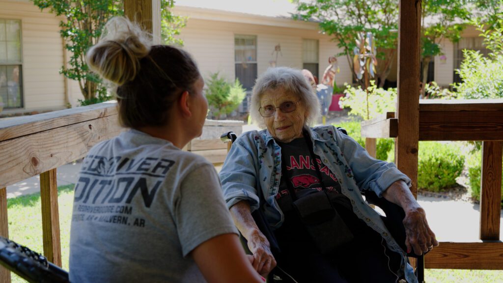 A memory care resident speaks with a nurse