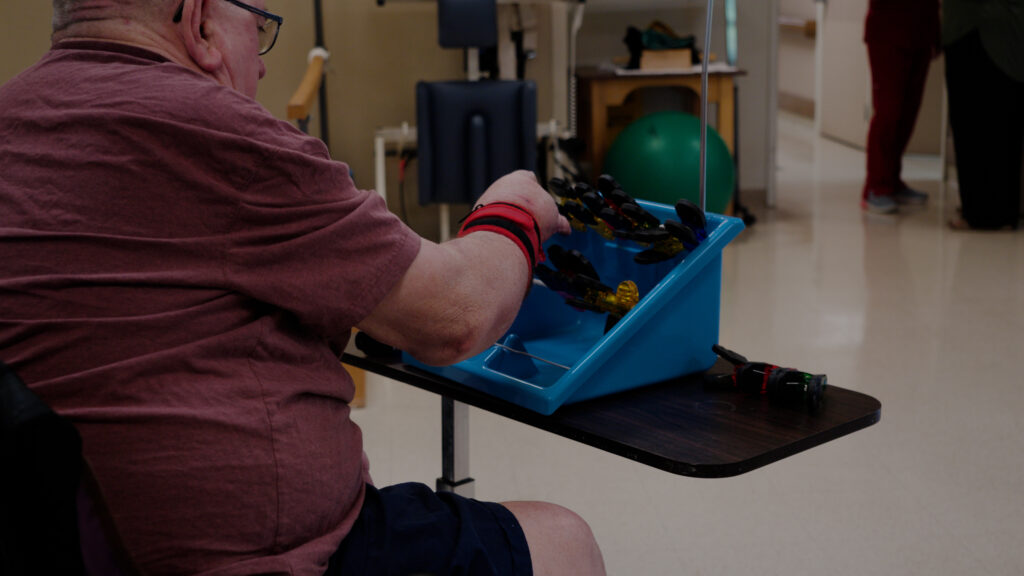 A man does physical therapy at a skilled nursing facility